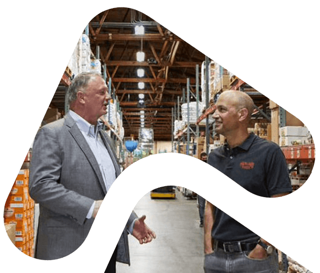 men talking in warehouse