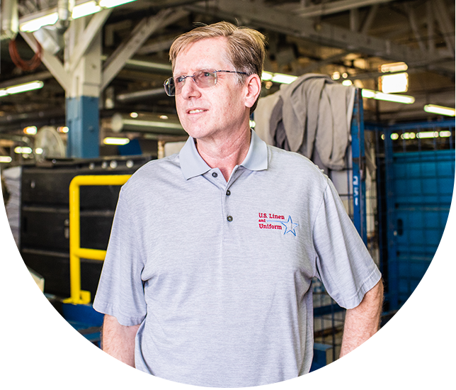 Business man smiles standing in warehouse