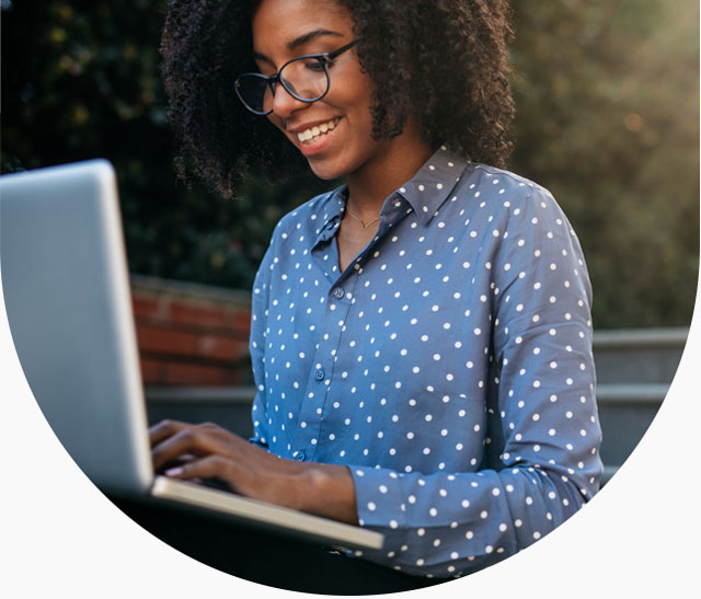 Person typing on laptop outside