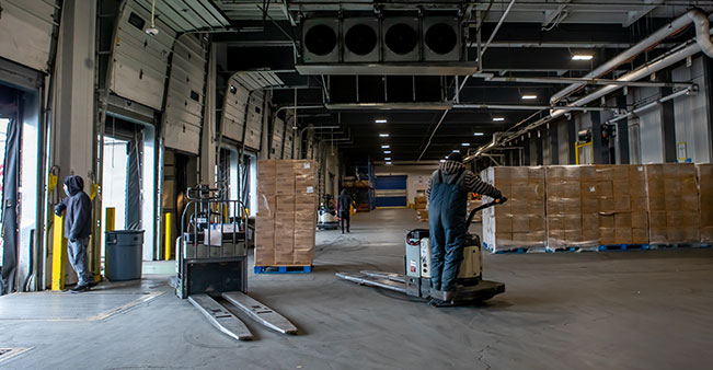 Person operates forklift in warehouse