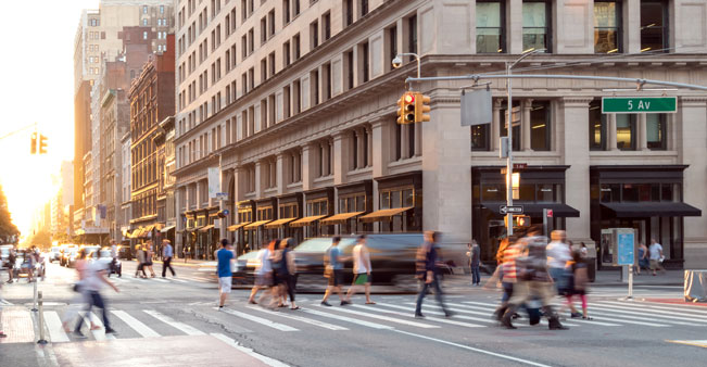 People cross busy New York street