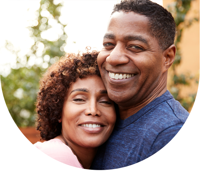 Couple embraces one another outdoors