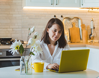 Women working on laptop in the kitchen