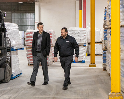Banker and owner are making conversation at the factory