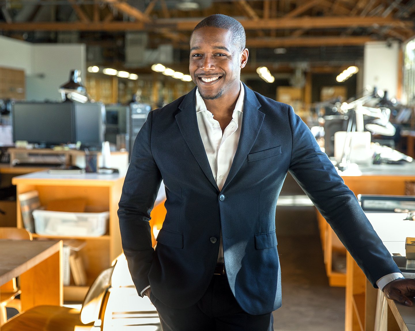 Banker is standing in a office with smile