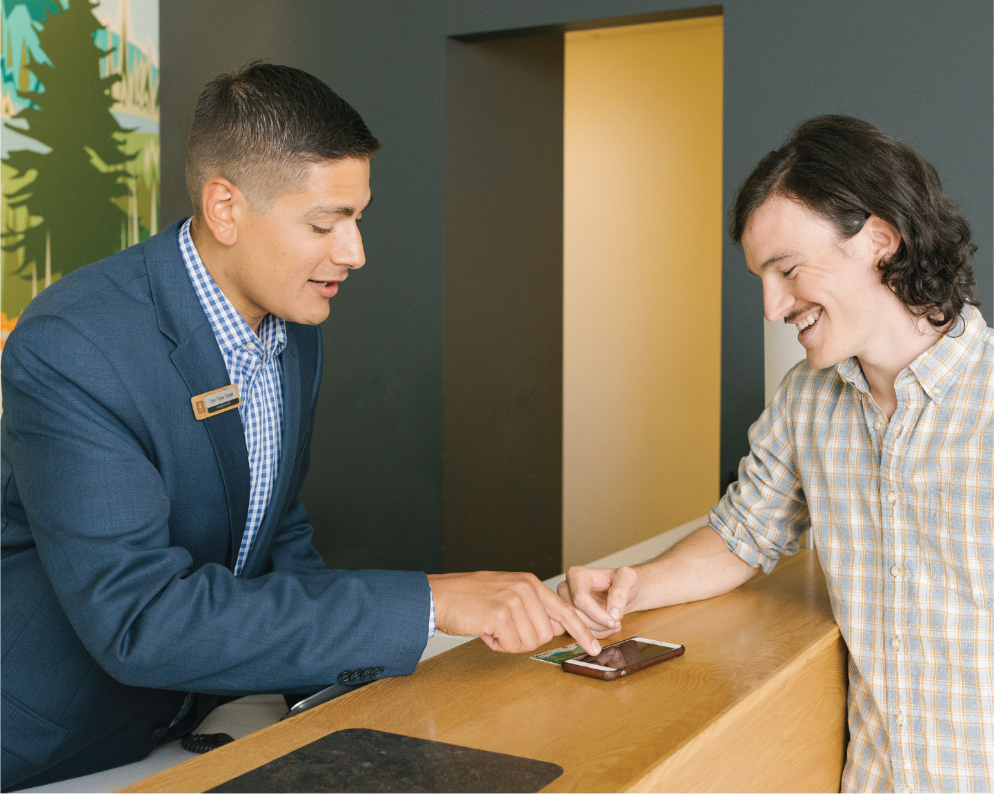 Banker helps customer with mobile phone app